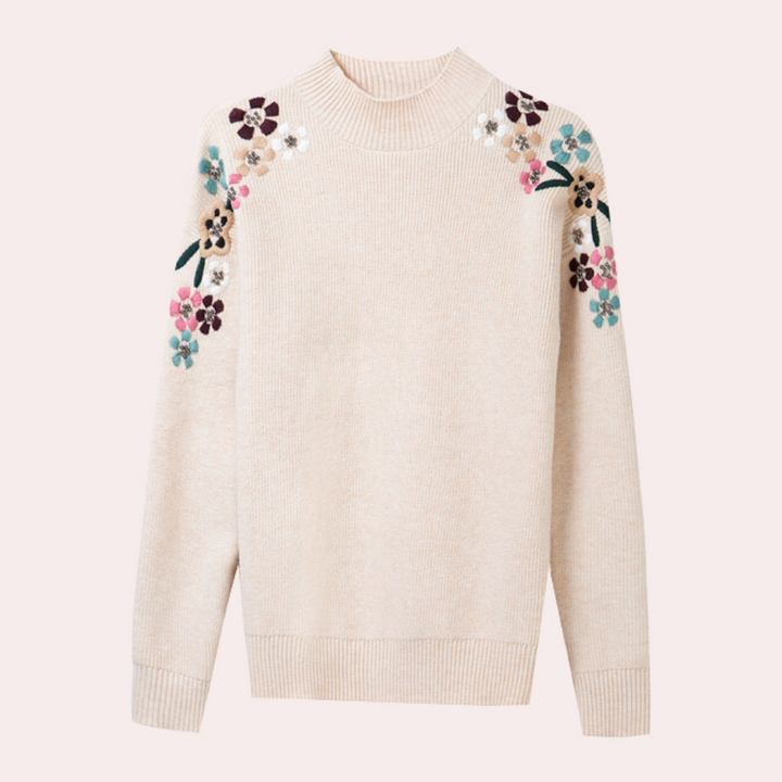 Mysig och bekväm damtröja med blommönster. Stickad tröja perfekt för ledig vardagsstil i höstkylan.
