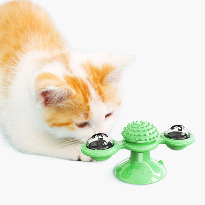 "Blå interaktiv väderkvarn kattleksak med genomskinliga behållare och gummiplexus i mitten på vit bakgrund."