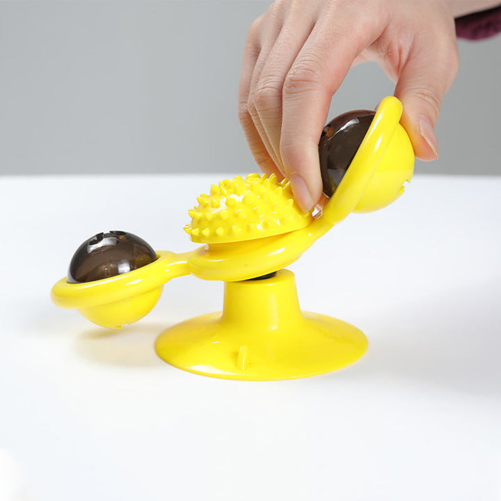 "Blå interaktiv väderkvarn kattleksak med genomskinliga behållare och gummiplexus i mitten på vit bakgrund."