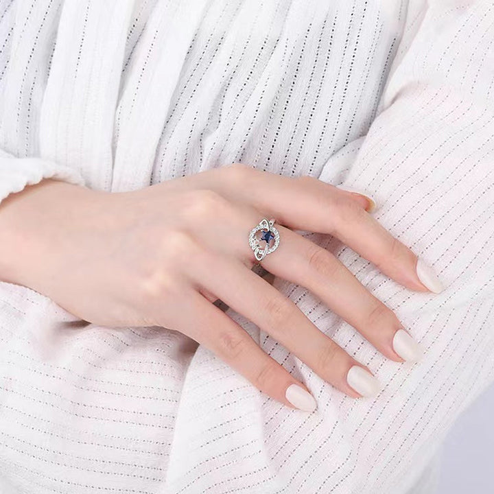 Blå stjärnformade planetariska smycken för kvinnor, med zirkoninlägg, i stål och koppar, elegant och kosmisk design.