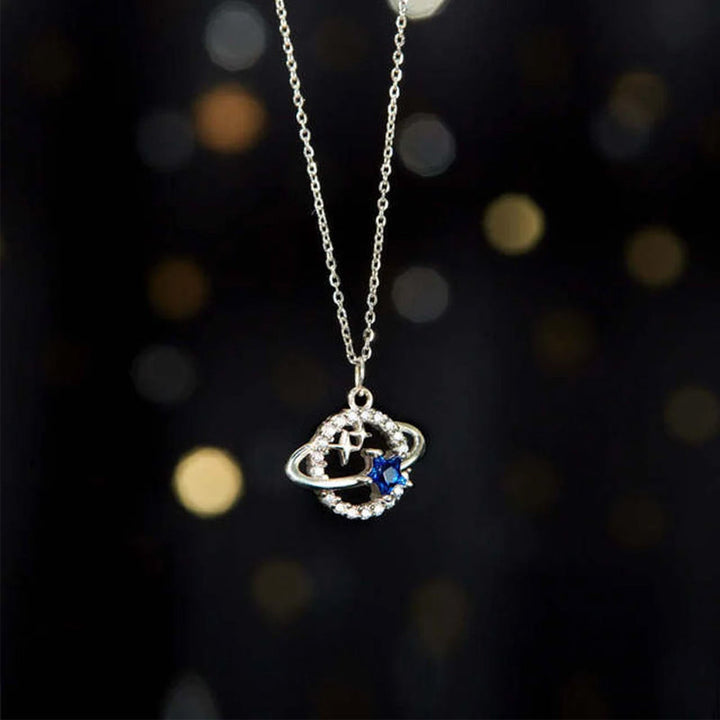Blå stjärnformade planetariska smycken för kvinnor, med zirkoninlägg, i stål och koppar, elegant och kosmisk design.