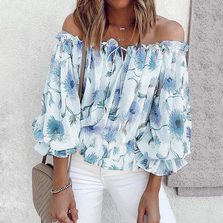 Blommig off shoulder volangblus dam med puffärmar i chiffong. Elegant och feminin topp för stilmedvetna kvinnor.