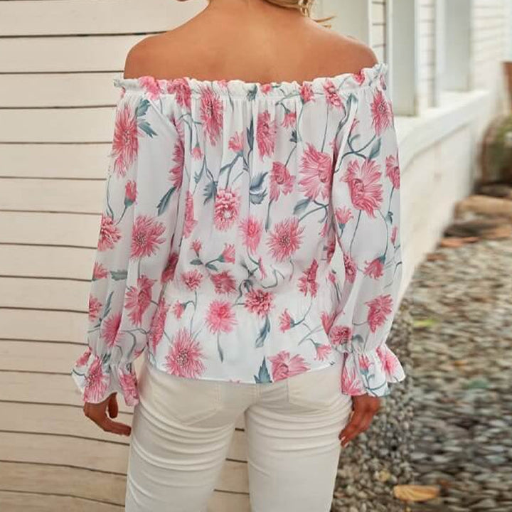 Blommig off shoulder volangblus dam med puffärmar i chiffong. Elegant och feminin topp för stilmedvetna kvinnor.