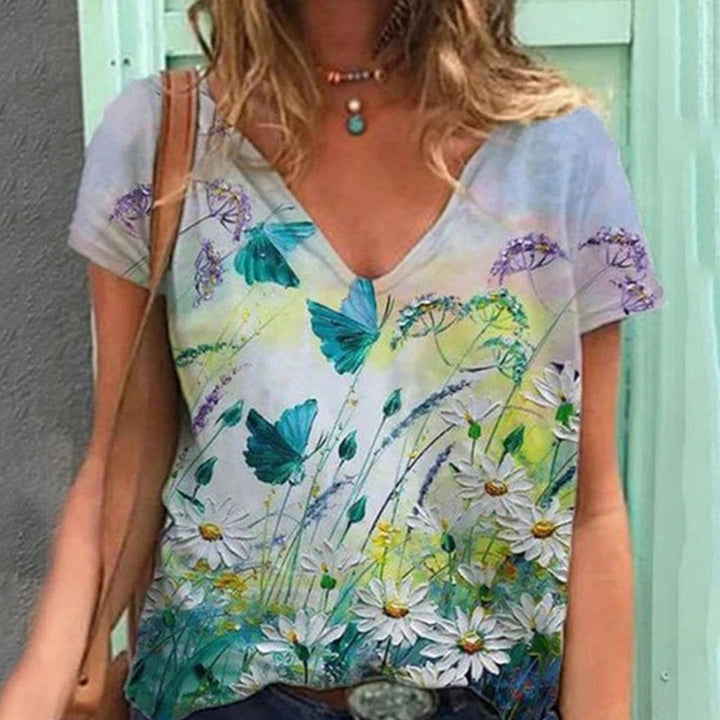 "Blommig V-ringad dam t-shirt i mjuk bomullsblandning med blomsterprint, kortärmad och modern design för vardagsbruk."