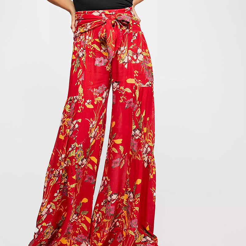 Blommiga vida byxor med elastisk midja för kvinnor, luftiga ben och färgglada blommönster, elegant och bekväm stil.