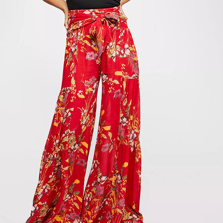Blommiga vida byxor med elastisk midja för kvinnor, luftiga ben och färgglada blommönster, elegant och bekväm stil.