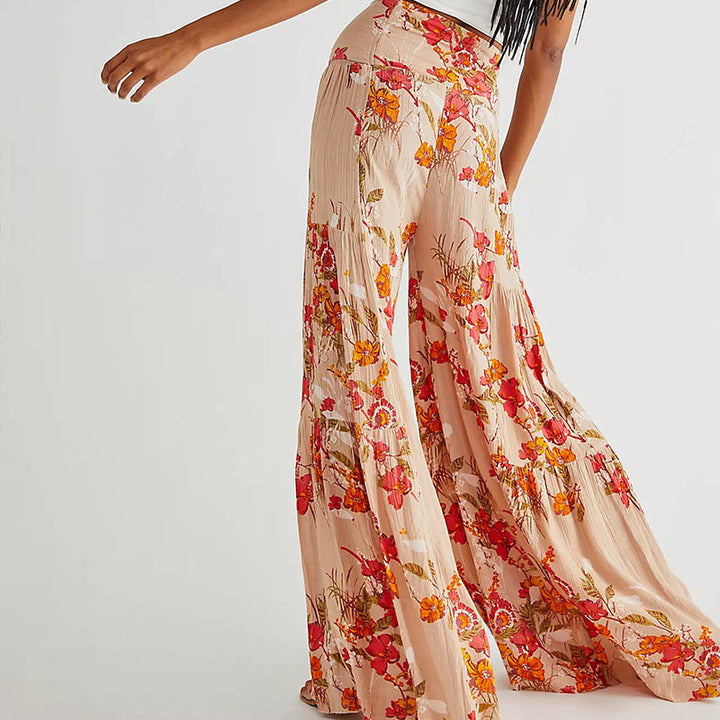 Blommiga vida byxor med elastisk midja för kvinnor, luftiga ben och färgglada blommönster, elegant och bekväm stil.