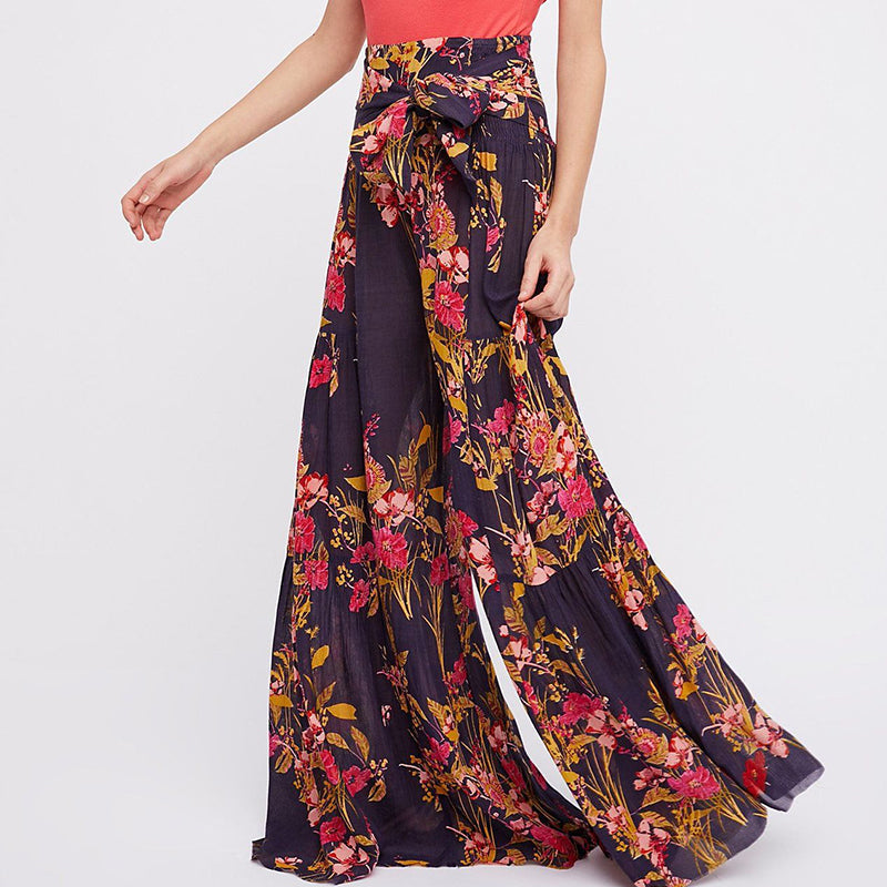 Blommiga vida byxor med elastisk midja för kvinnor, luftiga ben och färgglada blommönster, elegant och bekväm stil.