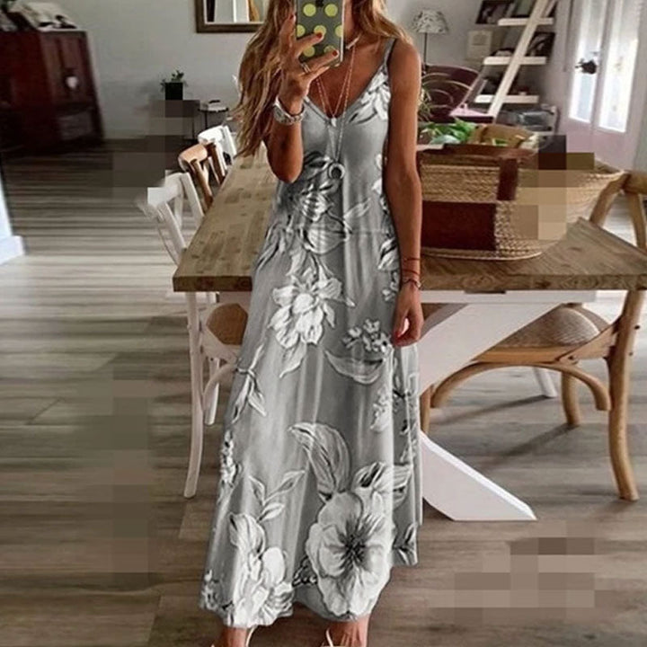 "Boho maxiklänning med färgglatt blommigt tryck, V-ringad, ärmlös, perfekt för sommar. Ger en elegant och avslappnad stil."