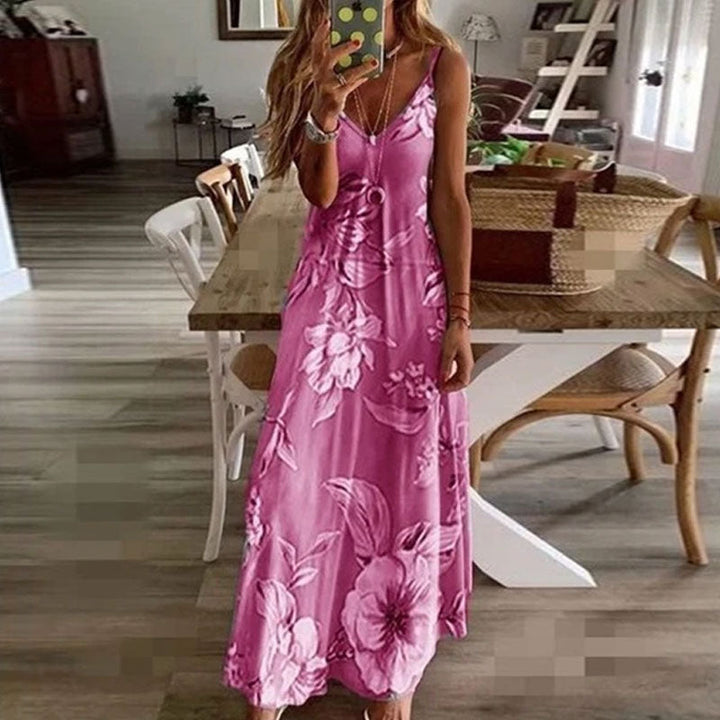 "Boho maxiklänning med färgglatt blommigt tryck, V-ringad, ärmlös, perfekt för sommar. Ger en elegant och avslappnad stil."