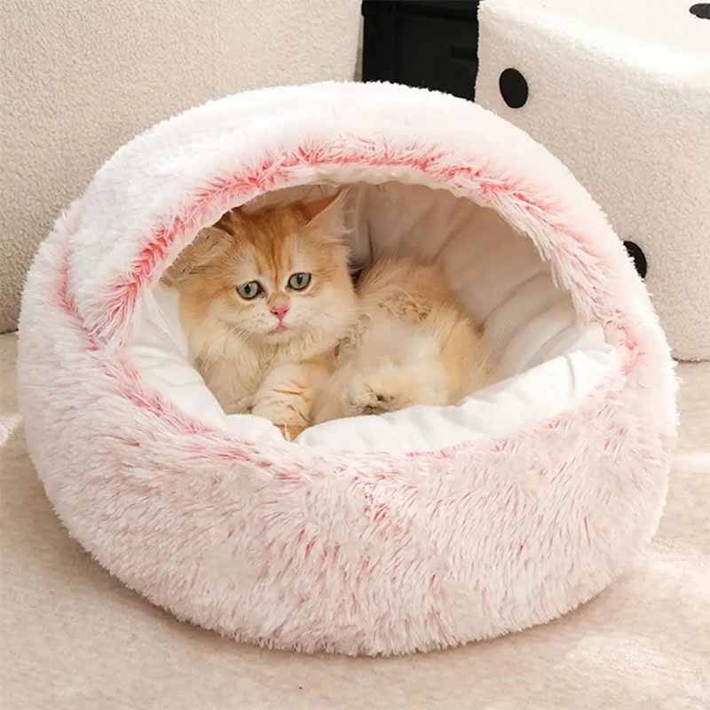 Mjuk rosa kattgrotta med tak i plysch. Varm kattsäng för mysiga stunder och säker sömn.