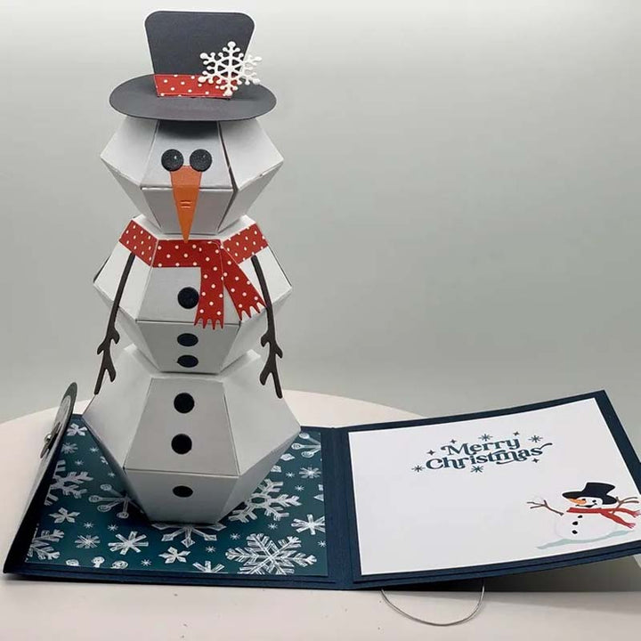"Charmigt 3D Pop Up julkort med snögubbe och renar, färgglad scen som sprider julglädje."