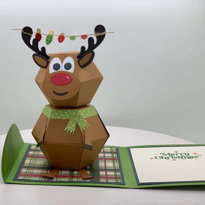 "Charmigt 3D Pop Up julkort med snögubbe och renar, färgglad scen som sprider julglädje."