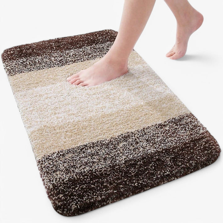 Halkfri Corinna badrumsmatta för ökad säkerhet och komfort. Superabsorberande mikrofiber skyddar badrumsgolvet.