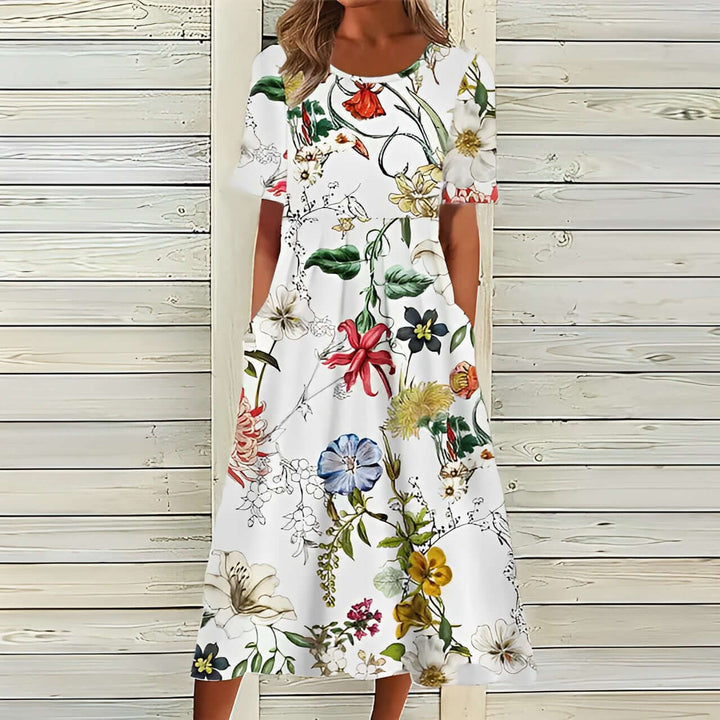 Elegant sommarklänning med blommönster – Midilängd och löst sittande