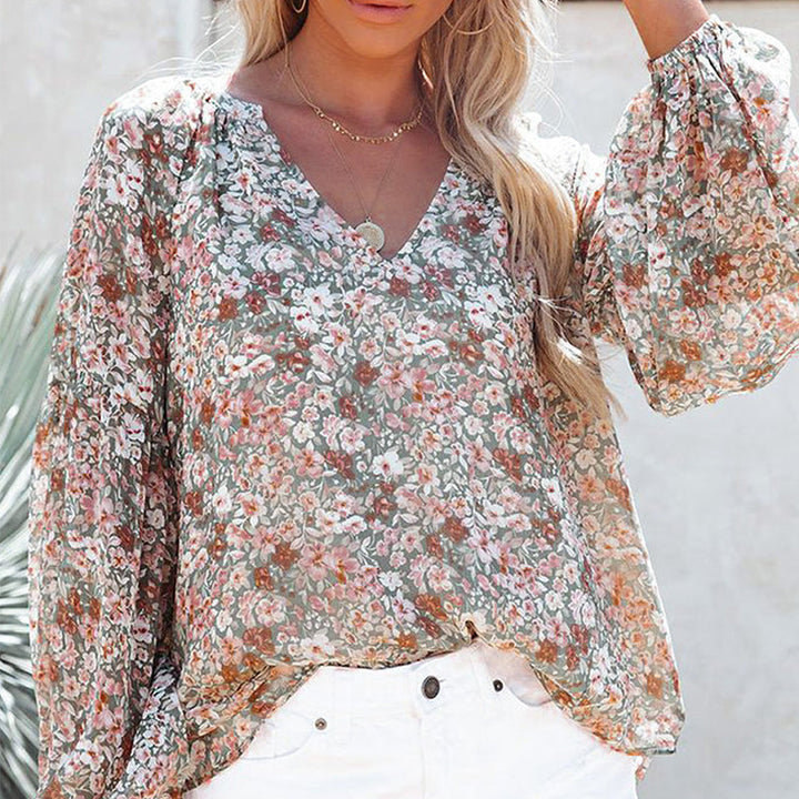 "Dam blommig boho blus, V-ringad långärmad, färgglatt blommönster på mjukt tyg, elegant och avslappnad design."