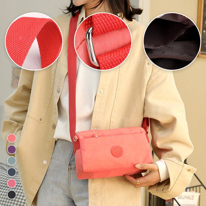"Dam casual nylon crossbody väska i flerfärgat mönster med justerbar rem och flera fack, stilren design."