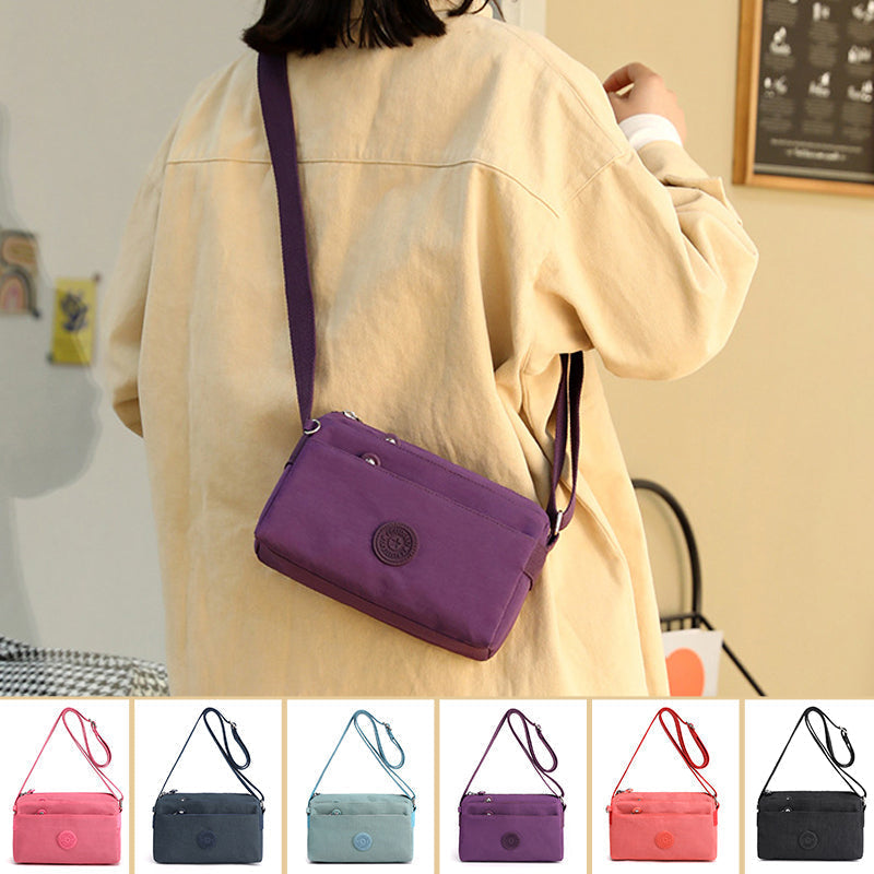 "Dam casual nylon crossbody väska i flerfärgat mönster med justerbar rem och flera fack, stilren design."
