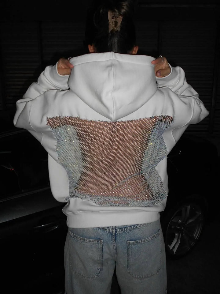 Dam glittrig hoodie med trendig öppen rygg. Festtopp som fångar rampljuset.
