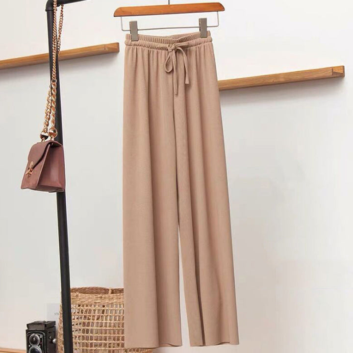 "Dam plus size vida byxor med hög midja, i silkesmjukt tyg och olika färger, elegant draperade för stil och komfort."