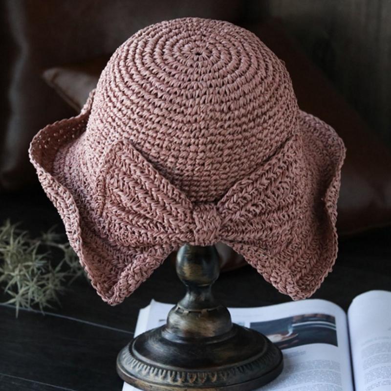 "Dam sommarhatt med rosett i pastellfärger, ventilerande och elegant för stil och komfort i sommarvärmen."