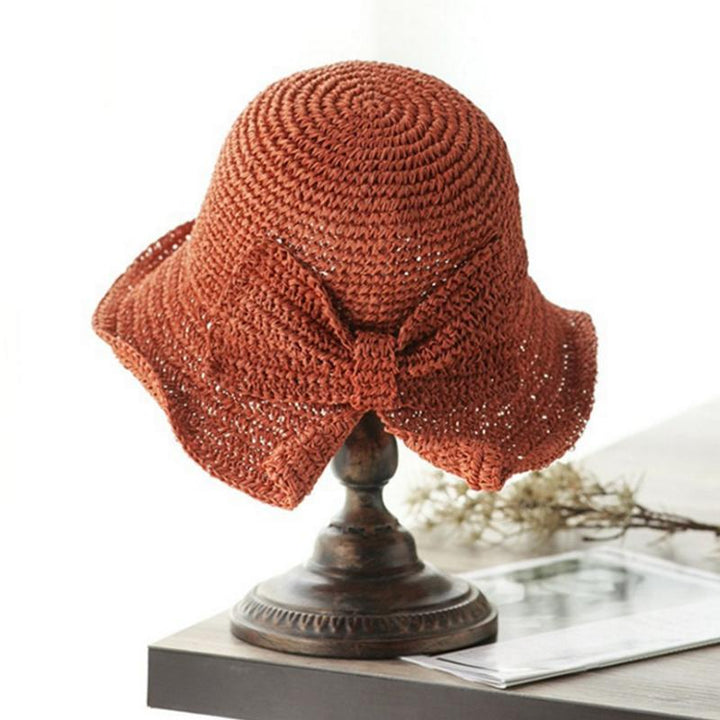 "Dam sommarhatt med rosett i pastellfärger, ventilerande och elegant för stil och komfort i sommarvärmen."