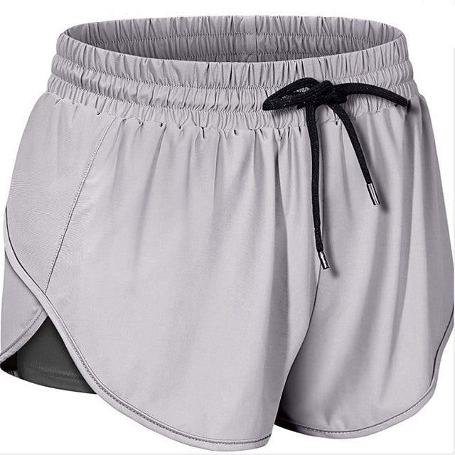 "Dam sportshorts i nylon och spandex, mjukt tyg, flera färger, avslappnad passform, perfekt för träning och fritid."