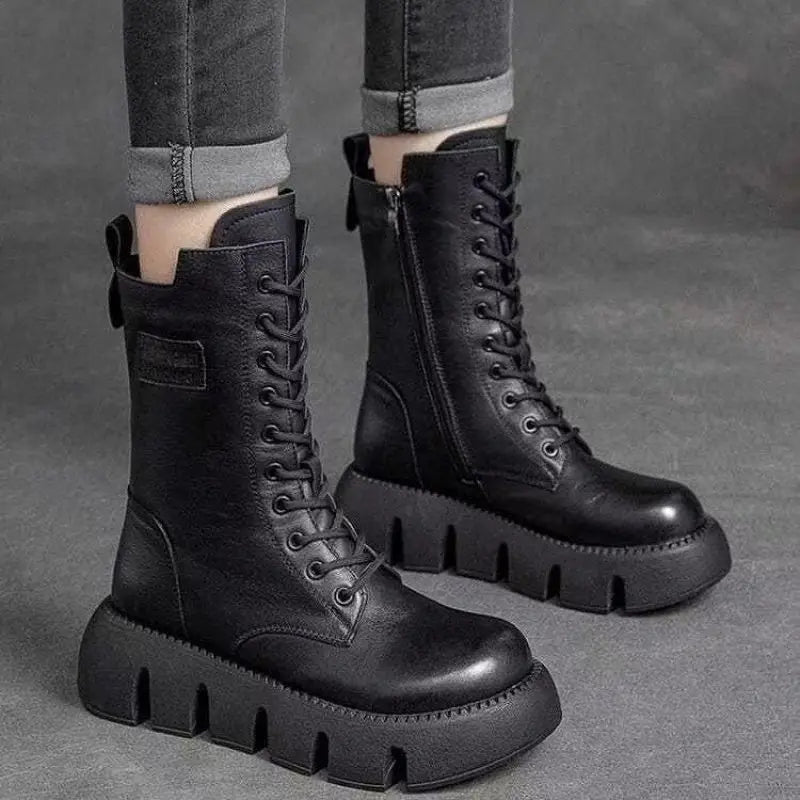 Svarta höga dam platå-kampsstövlar med snörning. Trendiga och bekväma för dammode.