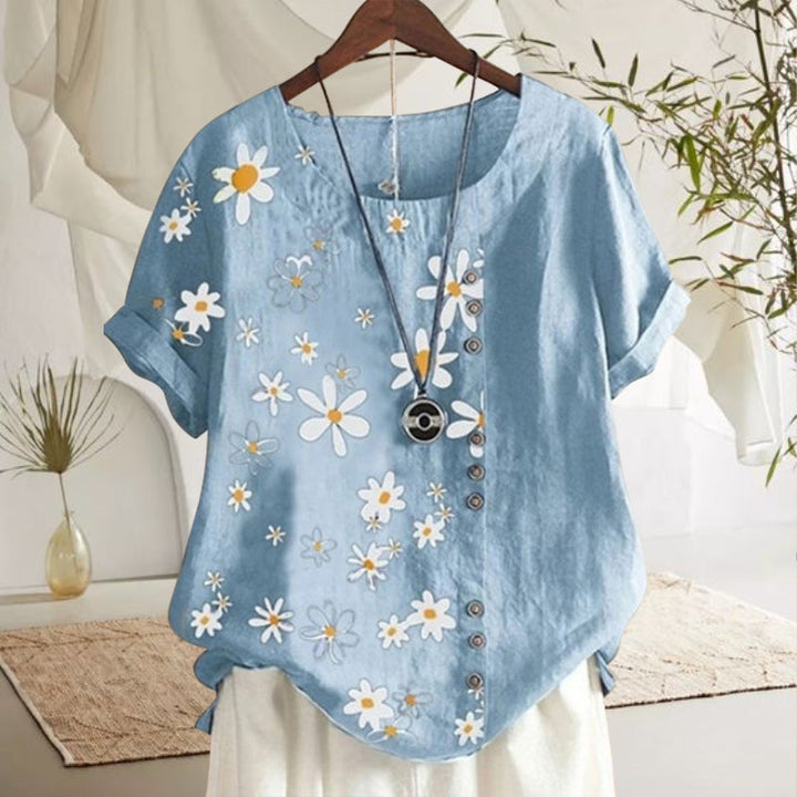 "Damblus med prästkrage och blommönster, rund hals, korta ärmar i mjuk bomull, elegant och avslappnad stil."