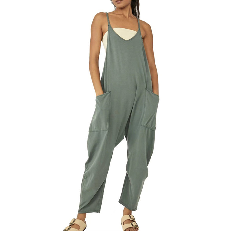 "Dambyxa i enfärgad V-neck jumpsuit med fickor, stilren och elegant design för vardaglig och avslappnad användning."