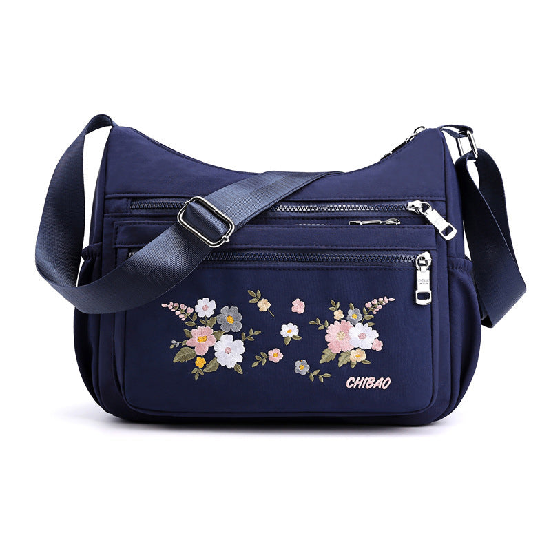 "Damer Axelväska i Nylon med Blombroderi, rymlig och stilren, justerbar axelrem, finns i flera färger."