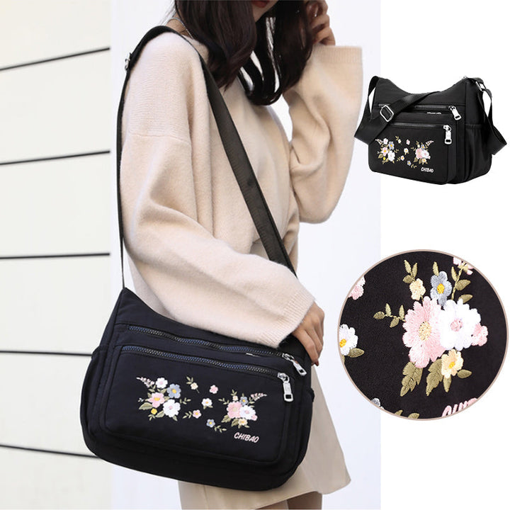 "Damer Axelväska i Nylon med Blombroderi, rymlig och stilren, justerbar axelrem, finns i flera färger."