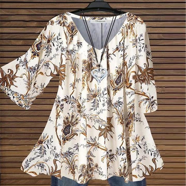 "Damer elegant blus med flare ärmar, V-ringning, kaki färg, visad från sidan för att framhäva sofistikerad design."