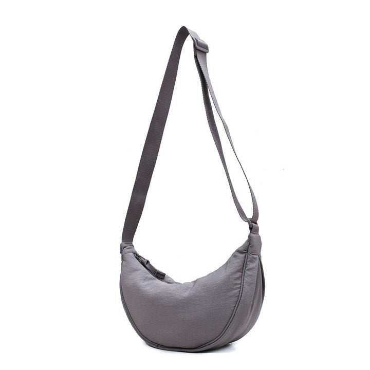 "Damer halvmåne crossbody-väska av slitstarkt nylon i gul färg med justerbar axelrem, stilren och praktisk."