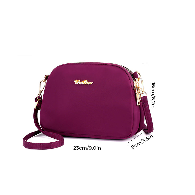 "Damer nylon crossbody kurirväska, vattenavvisande, justerbar axelrem, elegant design i flera färger, slitstark."