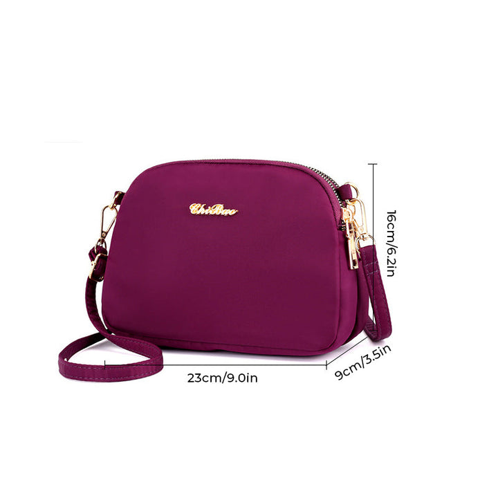 "Damer nylon crossbody kurirväska, vattenavvisande, justerbar axelrem, elegant design i flera färger, slitstark."