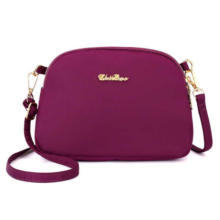 "Damer nylon crossbody kurirväska, vattenavvisande, justerbar axelrem, elegant design i flera färger, slitstark."