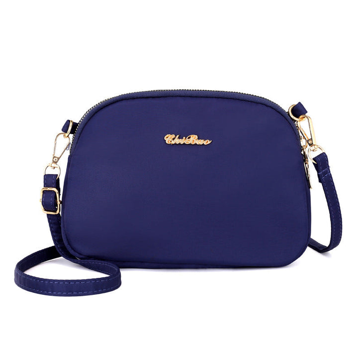 "Damer nylon crossbody kurirväska, vattenavvisande, justerbar axelrem, elegant design i flera färger, slitstark."