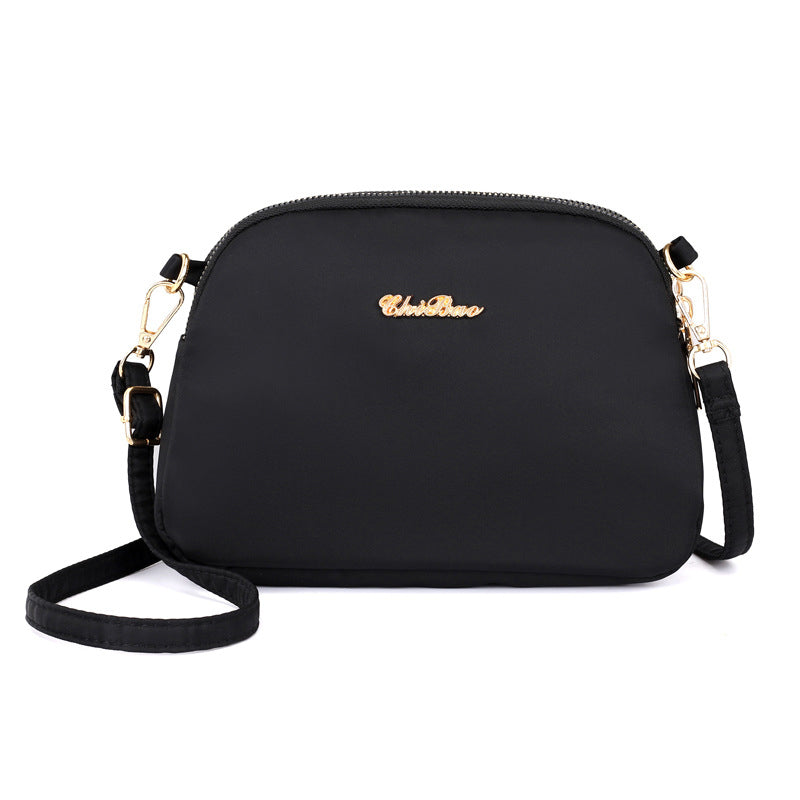 "Damer nylon crossbody kurirväska, vattenavvisande, justerbar axelrem, elegant design i flera färger, slitstark."