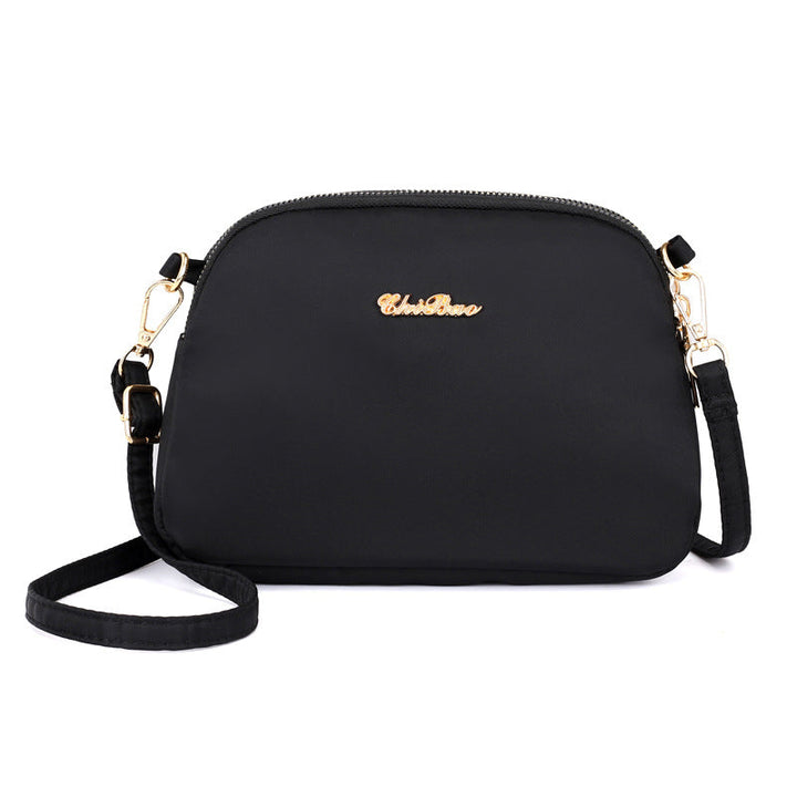 "Damer nylon crossbody kurirväska, vattenavvisande, justerbar axelrem, elegant design i flera färger, slitstark."