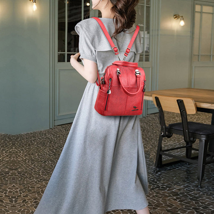 "Damer PU-läder multifunktionell ryggsäck i röd, elegant och slitstark design för vardag och resor, stor kapacitet."