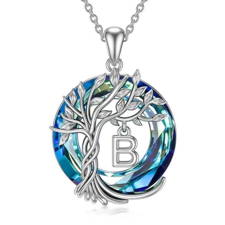 "Damhalsband i silver med livets träd och blå kristall, eleganta och symboliska smycken för unik kvinnlig stil."