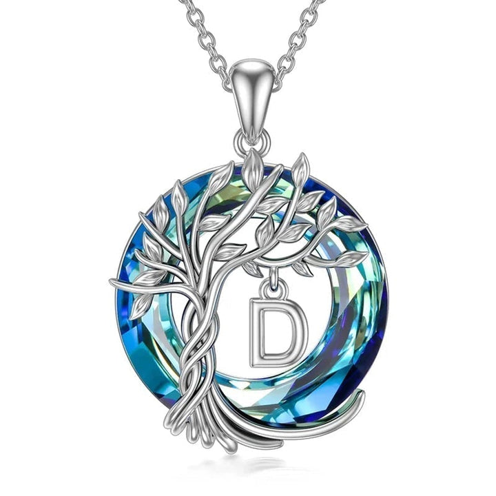 "Damhalsband i silver med livets träd och blå kristall, eleganta och symboliska smycken för unik kvinnlig stil."