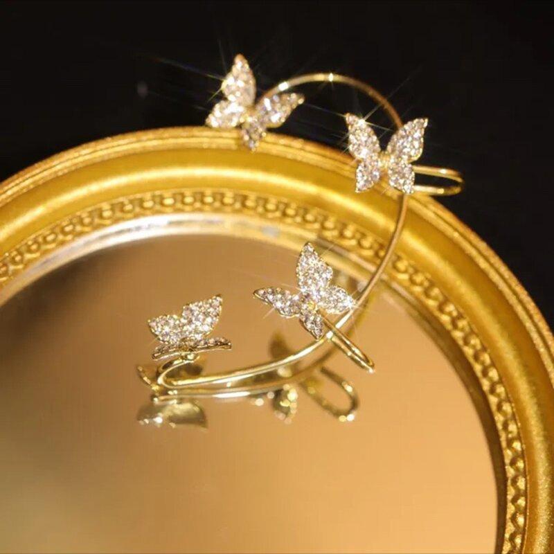 "Damhängande zirkonörhängen i guld och silver, elegant design, strålande stenar, perfekt accessoar för alla tillfällen."
