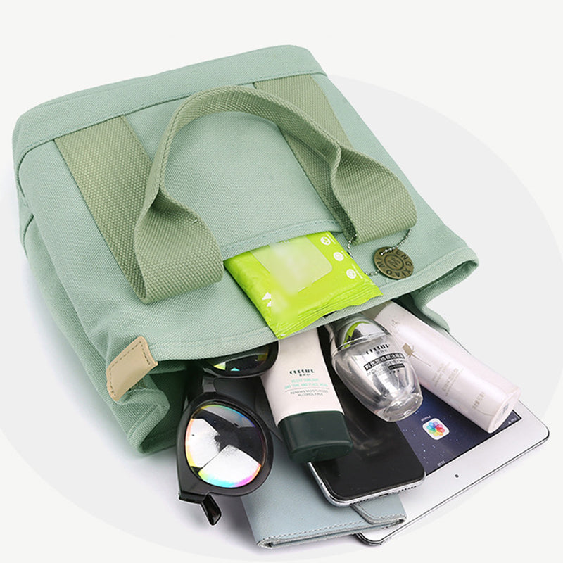 "Damhögkapacitets-canvasväska med flerficksdesign, färgstark och slitstark med säkra dragkedjor. Praktisk accessoar."