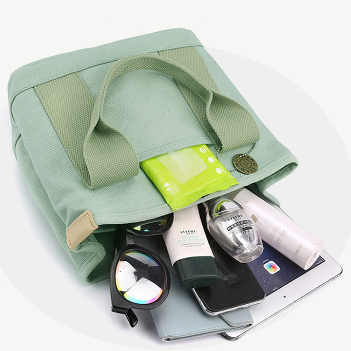 "Damhögkapacitets-canvasväska med flerficksdesign, färgstark och slitstark med säkra dragkedjor. Praktisk accessoar."