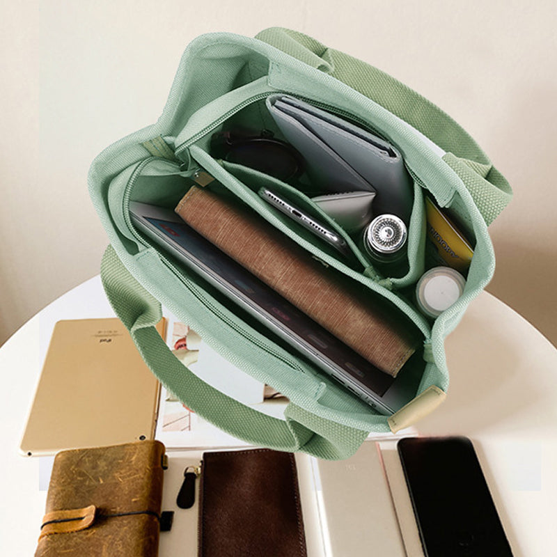 "Damhögkapacitets-canvasväska med flerficksdesign, färgstark och slitstark med säkra dragkedjor. Praktisk accessoar."