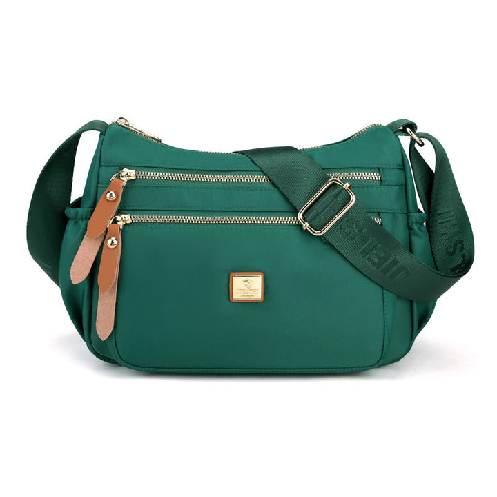 Damkurirväska i nylon med flera fack, stilren och rymlig, perfekt för modern organisering och dagliga behov.