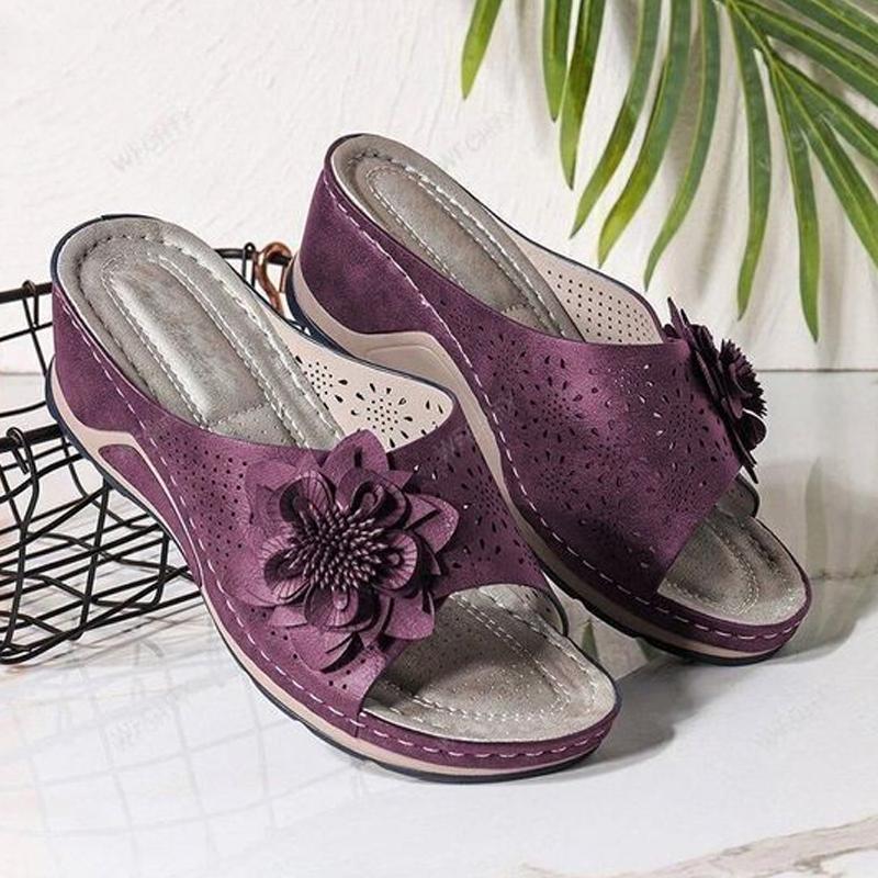 "Damsandaler med ihåliga snidade kilklackar, beige färg, öppen tå och blommiga detaljer för modern stil och komfort."