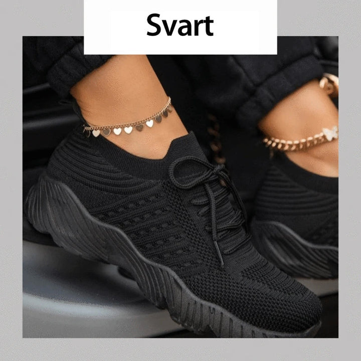 "Damskor casual sneakers, andningsbara och bekväma, i vit design med ergonomiskt stöd och halkfri sula."